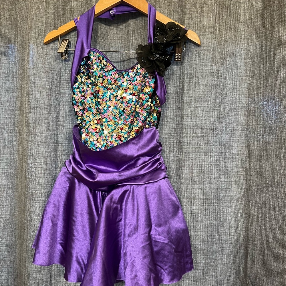 Multi-colored sequin bodice with black straps and snaps around neck.